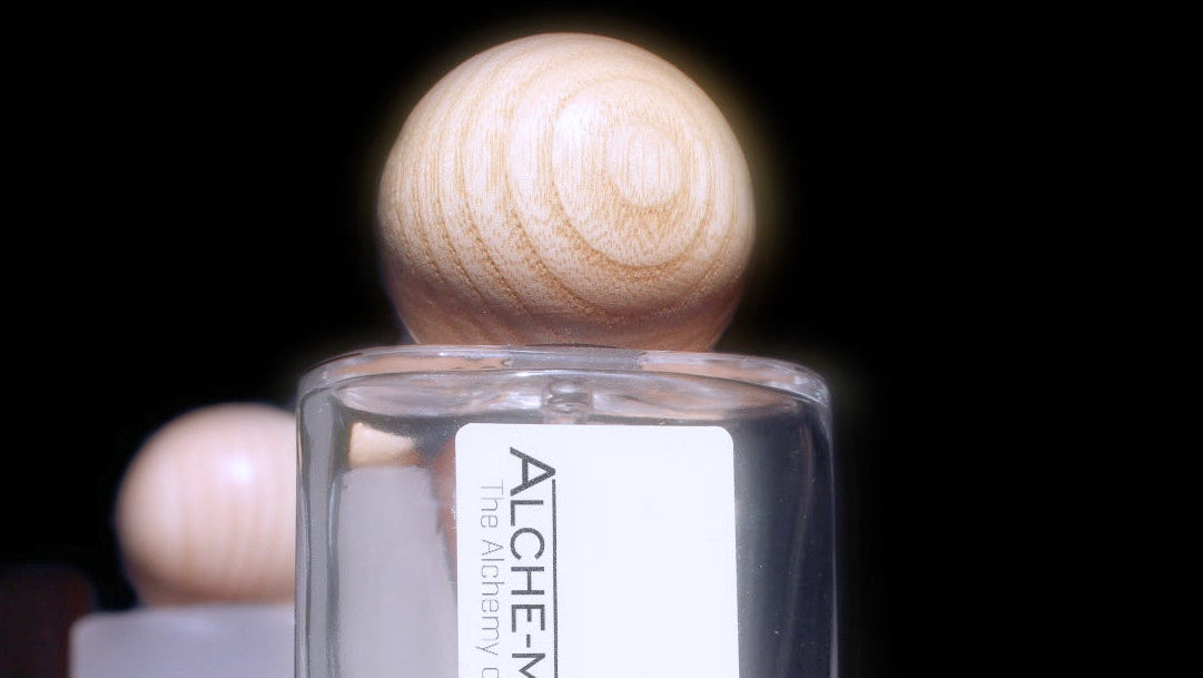 Perfume bottle with wooden cap on a dark background